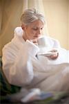 Woman in Bathrobe with Coffee Cup