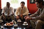 Businessmen Having Coffee in Cafe