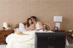 Couple Watching Television in Bed