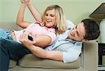 Young Couple Fighting for Remote Control