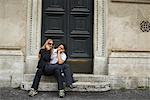 Couple Sitting on Steps, Woman Talking on Cellular Phone