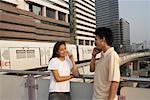 Man and Woman Talking on Cellular Phones