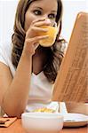 Woman reading at breakfast