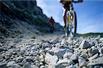 People cycling on a rocky path