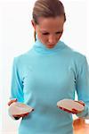 Woman holding silicon breast implants