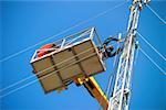 Man on crane working on mast