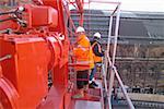 Men on crane at work site