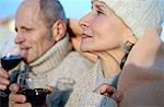 Senior couple drinking wine in blanket