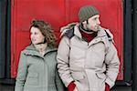 Couple standing outside a hut