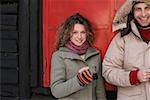 Couple in winter clothes with warm drinks