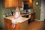 Girl Sitting on Kitchen Counter