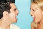 Close-Up Portrait of Man and Woman Screaming at Each Other