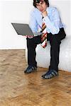 Businessman Sitting on Bubble Wrap Roll