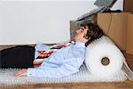 Businessman Sleeping on Bubble Wrap