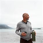 Man Drinking from Thermos on Beach - Stock Photo - Masterfile -  Rights-Managed, Artist: Masterfile, Code: 700-00606349