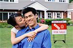 Portrait of Couple in Front of New Home