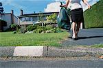 Woman Taking Garbage to Curb