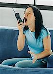 Woman Yelling into Telephone