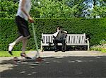 Man Reading Newspaper on Park Bench