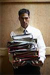 Businessman Carrying Binders