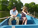 Man and Woman Paddling Rowboat Together