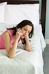 Woman on Bed with Cellular Phone