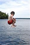 Boy Jumping into Lake Rosseau, Muskoka, Ontario, Canada