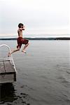 Young Boy Jumping into Lake