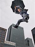 Businessman Falling, Holding Umbrella