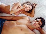 Couple in Bed, Woman on Cellphone