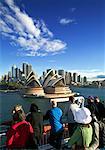 Tourists on Ferry Boat Looking at Sydney Skyline, New South Wales, Australia