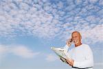 Homme avec carte et téléphone cellulaire