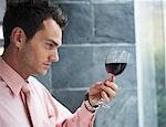 Man Looking at Glass of Wine