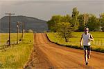 Man Running On Dirt Road, Boulder, Colorado, USA