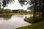 Man Fishing in Pond in Victory Park, St Petersburg, Russia