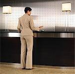 Businesswoman at Front Desk in Hotel