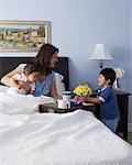 Boy Bringing Mother Breakfast in Bed