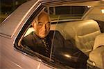 Portrait of Businessman In Backseat of Car