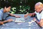 Father and Son Playing Checkers