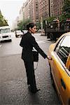 Business Woman Getting into Taxi