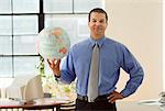 Portrait of Businessman Holding Globe