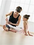 Ballet Instructor Putting Bandaid on Girl's Foot