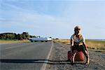 Woman Hitchhiking At The Side of A Country Road