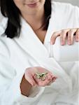 Woman Pouring Pills into her Hand