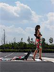 Woman Walking in Parking Lot With Clothes Spilling Out Of Luggage - Stock  Photo - Masterfile - Rights-Managed, Artist: Masterfile, Code: 700-00644015