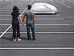 Couple in Parking Lot, Looking At Covered Car