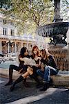 Women Looking at Map by Fountain, Paris, France