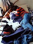 Boy sleeping on messy bed