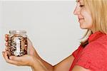 Woman holding jar of pennies