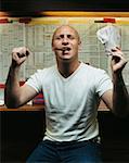 Man celebrating win at betting shop